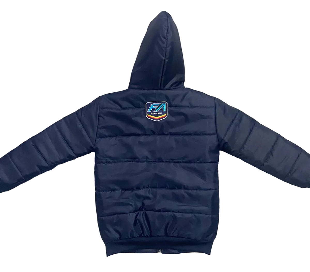 A navy blue hooded puffer jacket is laid flat on a textured gray concrete surface, viewed from the back. It features horizontal quilting, a small shield-shaped logo patch on the upper back, and ribbed cuffs and hem.