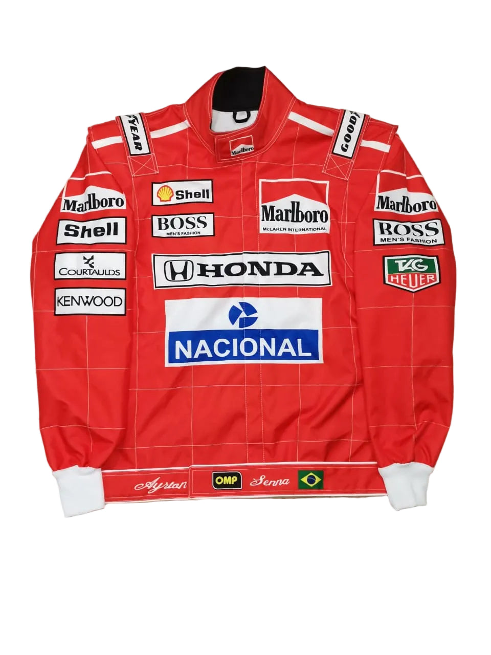 A red long-sleeve racing-style jacket or sweater laid flat on a beige stone-textured background, covered with multiple sponsor logos including Marlboro, Honda, Shell, BOSS, Courrèges, Kenwood, TAG Heuer, and Nacional.