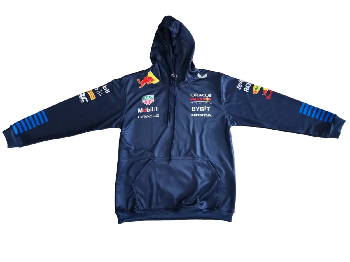 A navy blue Red Bull Racing zip-up hoodie with sponsor logos and team branding, laid flat on a beige marble-patterned floor.