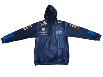 A navy blue Red Bull Racing zip-up hoodie with sponsor logos and team branding, laid flat on a beige marble-patterned floor.