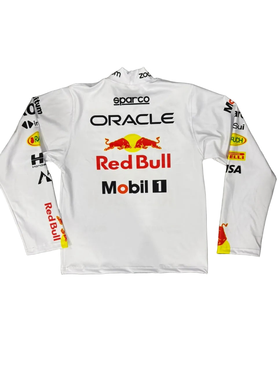 A white long-sleeve Oracle Red Bull Racing sponsor jersey is laid flat on a gray marble floor, with the wearer's bare feet visible at the bottom edge. The jersey features prominent sponsor logos including Oracle, Red Bull, Mobil 1, Sparco, and Shell.